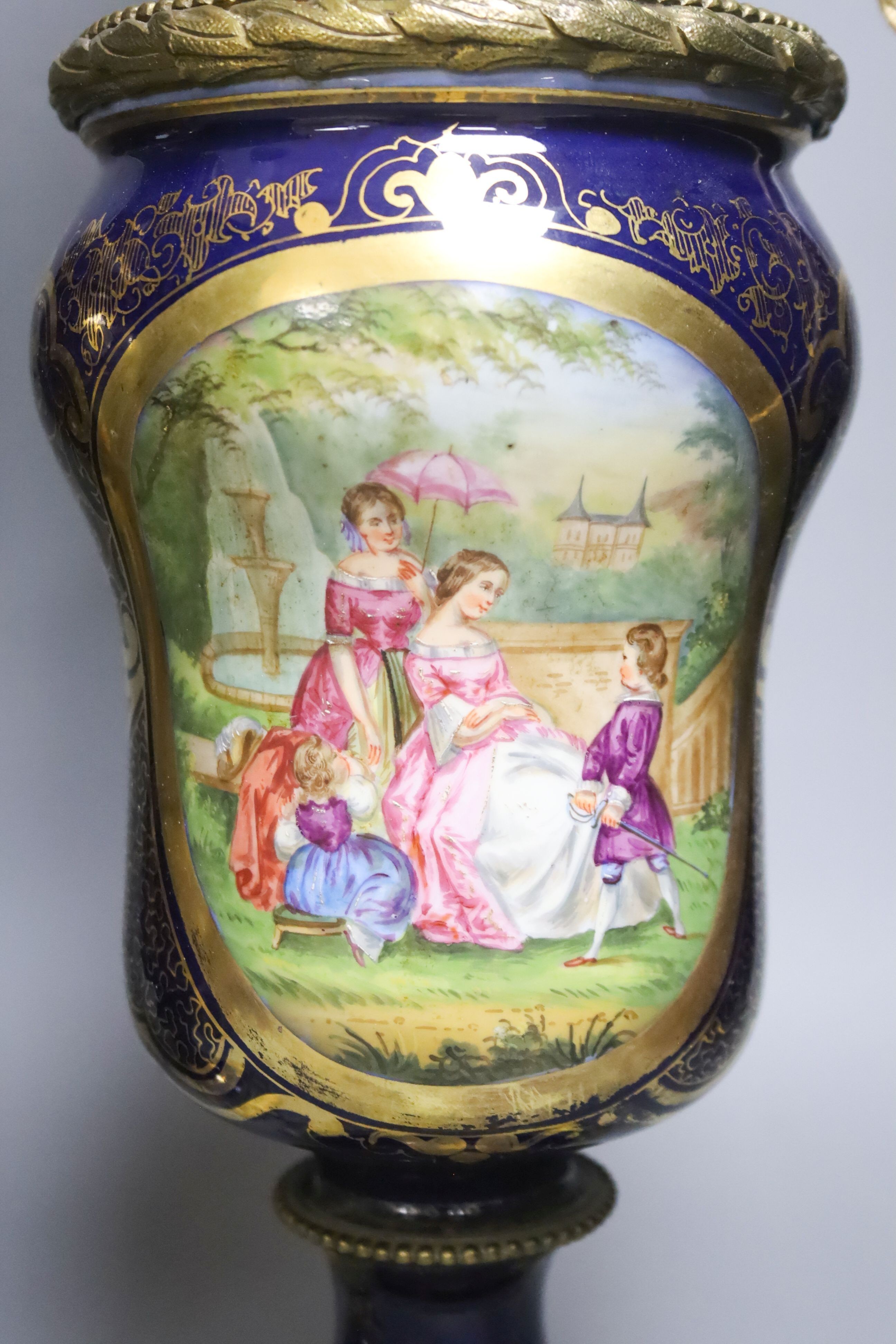 A matched pair of hand-painted Paris porcelain converted oil lamps 57cm